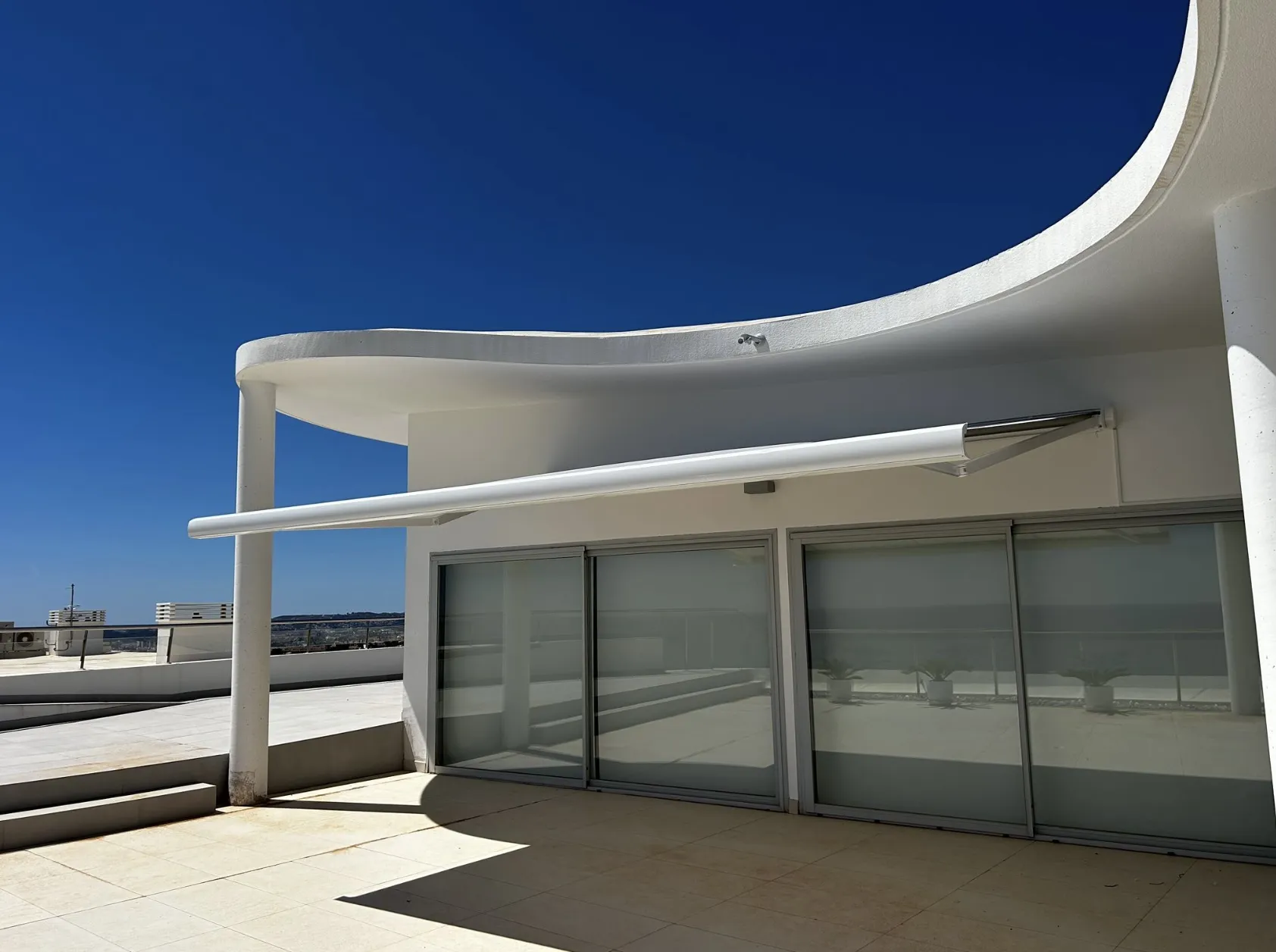 Luxaflex awning retracted into its cassette housing on a Costa del Sol rooftop terrace